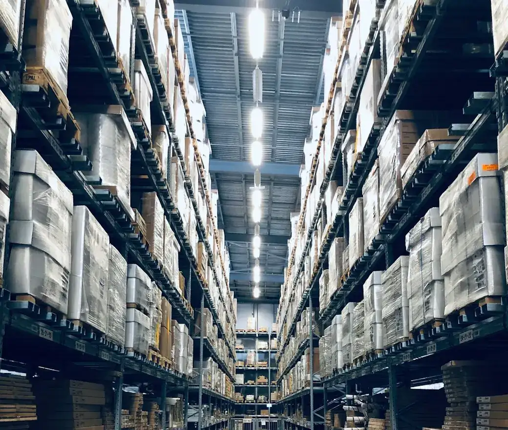 A warehouse aisle with tall shelving on both sides