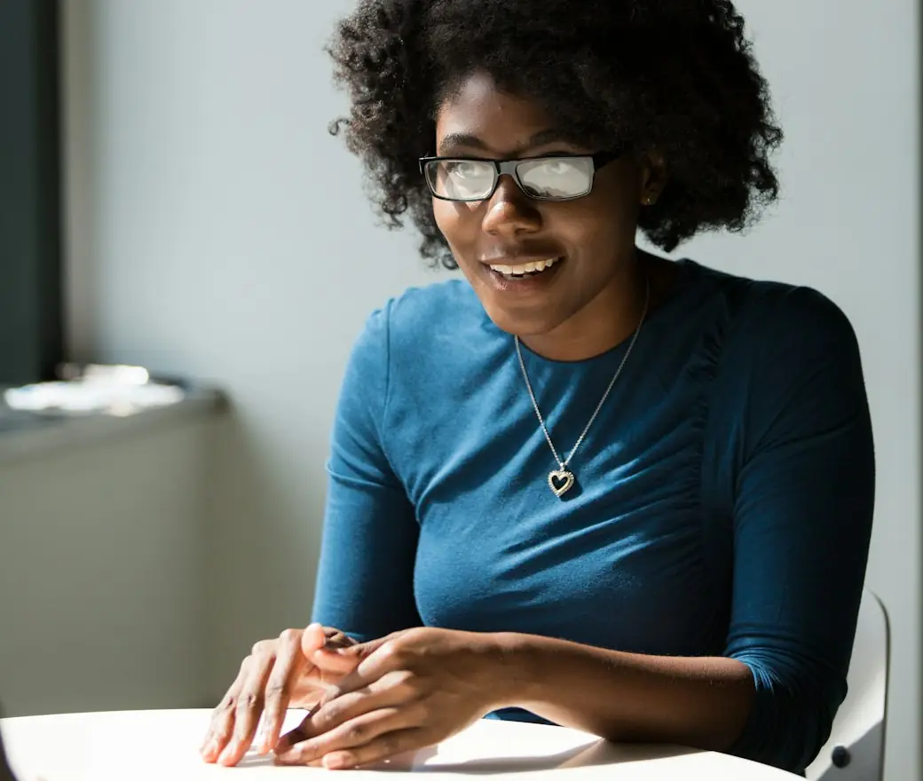 A candidate smiling across the table in an interview
