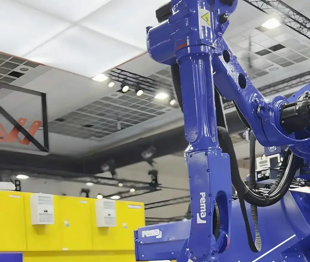 An industrial robot arm working on a metal part