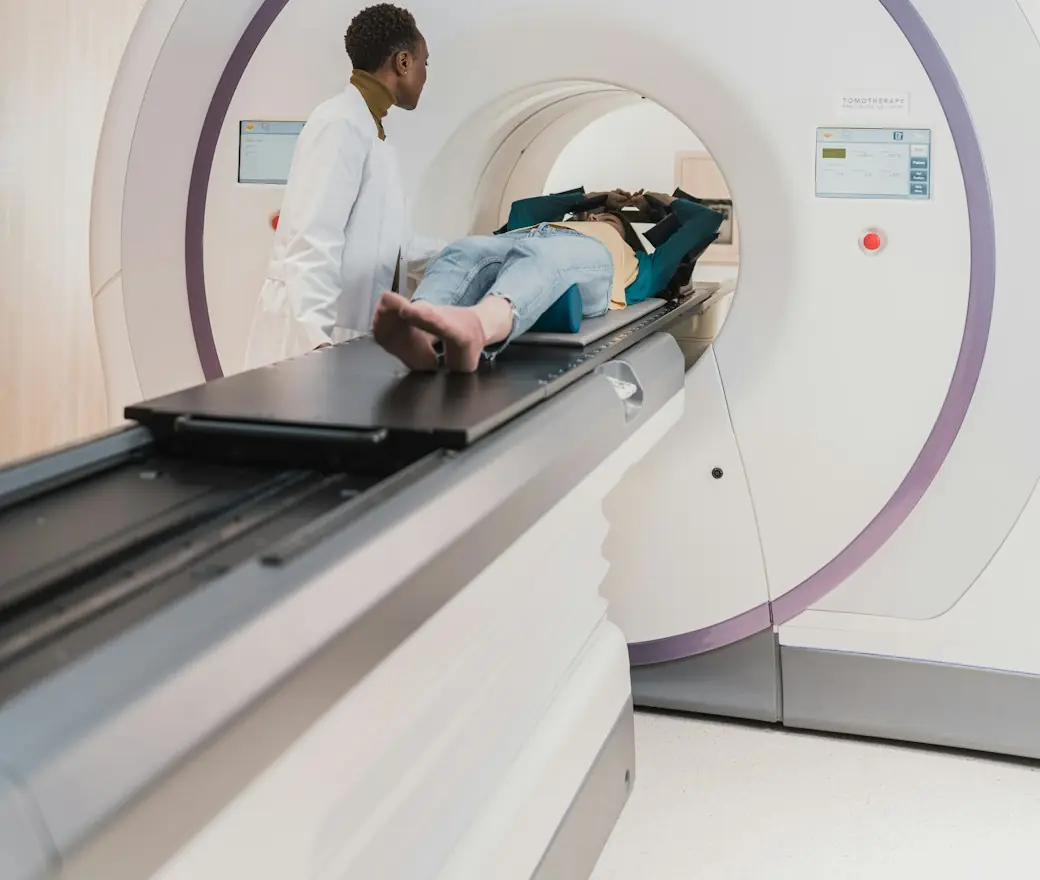 Clinicians beside a radiotherapy machine