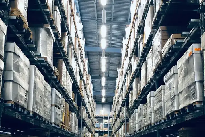 A warehouse aisle with tall shelving on both sides