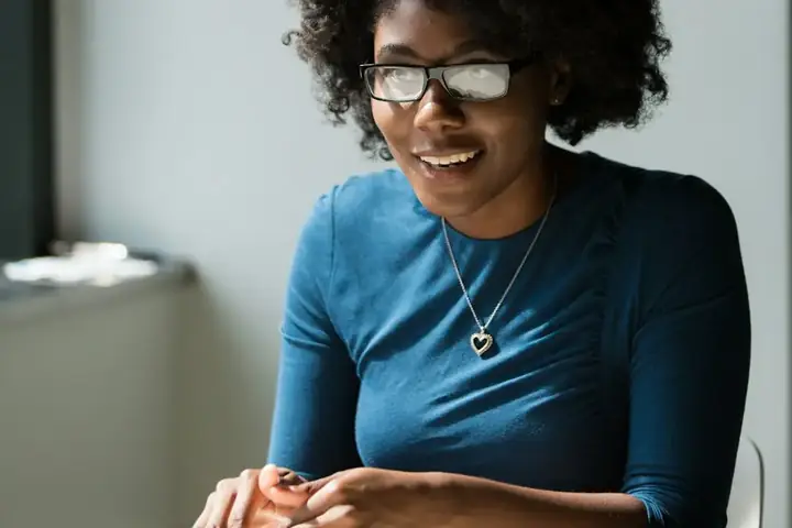 A candidate smiling across the table in an interview