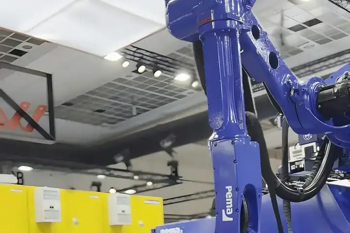 An industrial robot arm working on a metal part