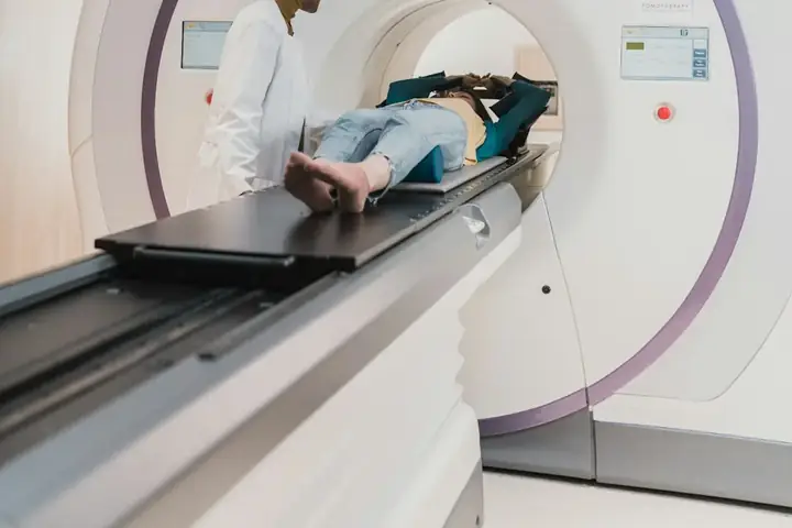 Clinicians beside a radiotherapy machine